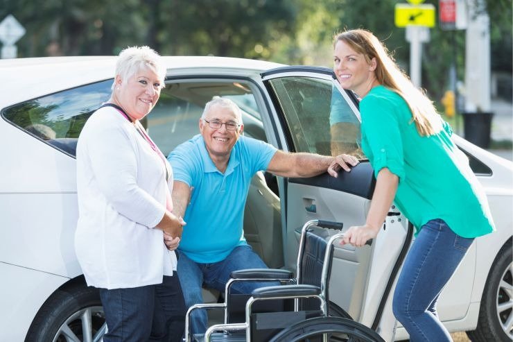 A caregiver safely accompanying a senior to an appointment